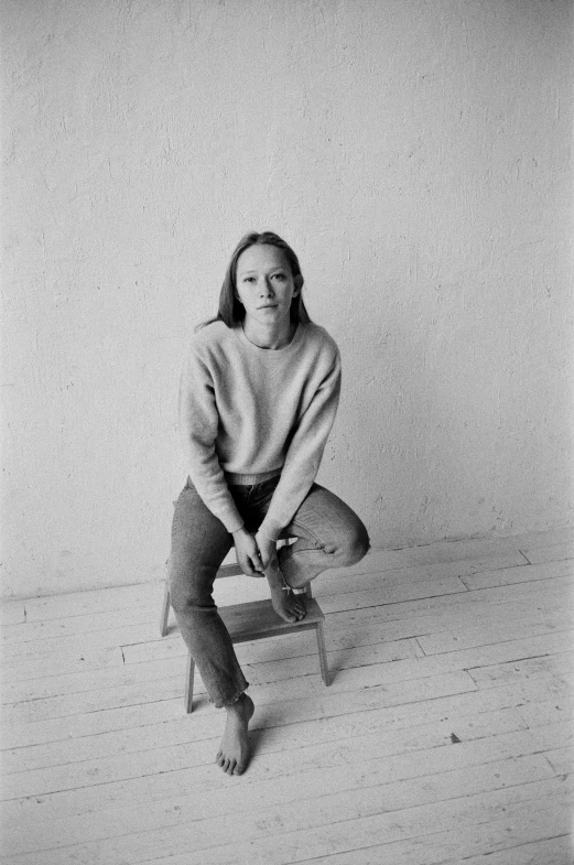 a black and white photo of a woman sitting on a chair, inspired by Sarah Lucas, greta thunberg, ffffound, miranda otto, photo 1998