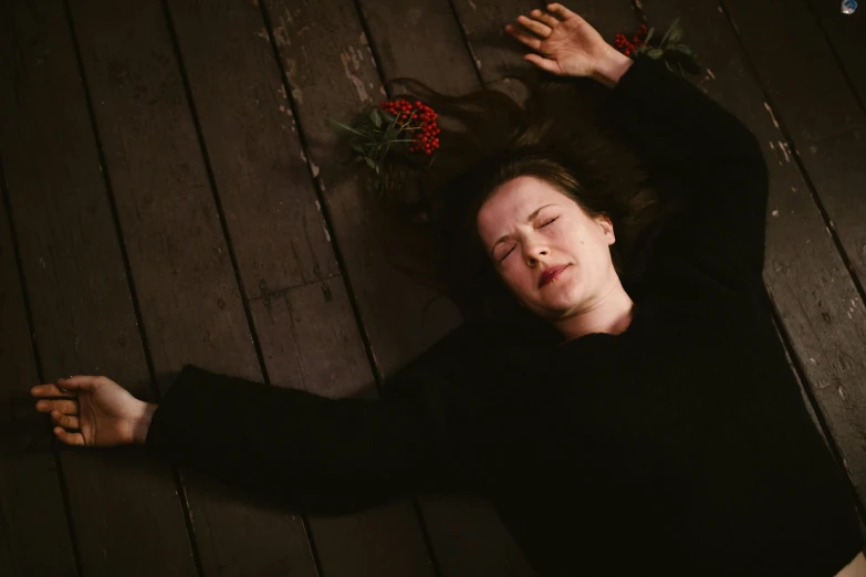 a woman laying on top of a wooden floor, by Marina Abramović, pexels contest winner, renaissance, miranda otto as eowyn, funeral, blair witch project, clarice starling