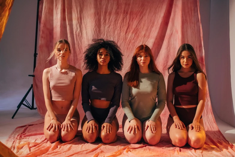 a group of women sitting on top of a pink blanket, pexels contest winner, antipodeans, madison beer as leeloo, muted colour, ( redhead, physical : tinyest midriff ever