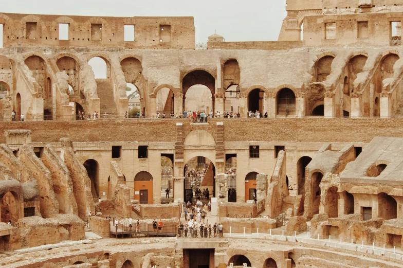 a group of people standing inside of a building, a photo, pexels contest winner, neoclassicism, panorama of crooked ancient city, coliseum, 🦩🪐🐞👩🏻🦳, brown