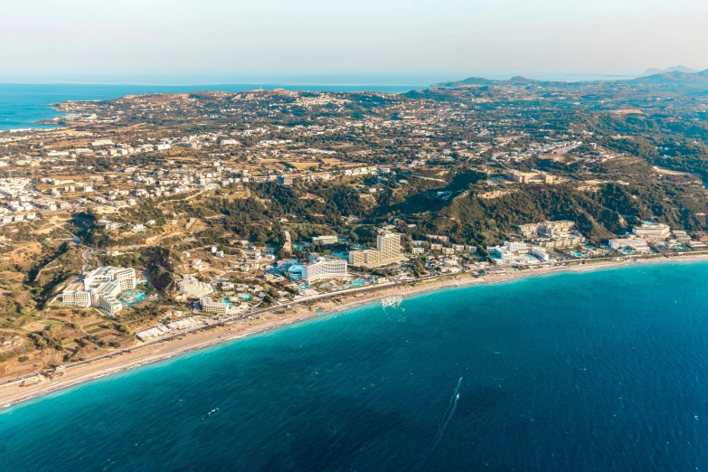 a large body of water next to a beach, by Julian Allen, pexels contest winner, renaissance, cyprus, aerial view of a city, thumbnail, marbella landscape