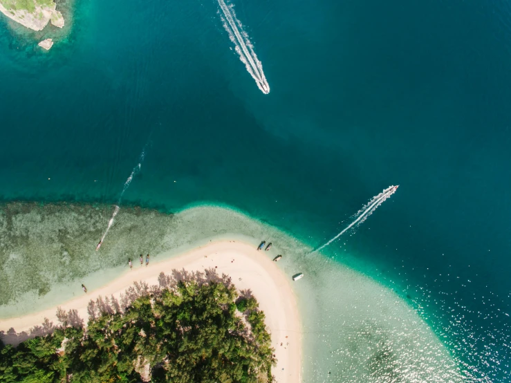 a couple of boats that are in the water, by Emma Andijewska, pexels contest winner, hurufiyya, tropical island, air shot, celebrating, thumbnail