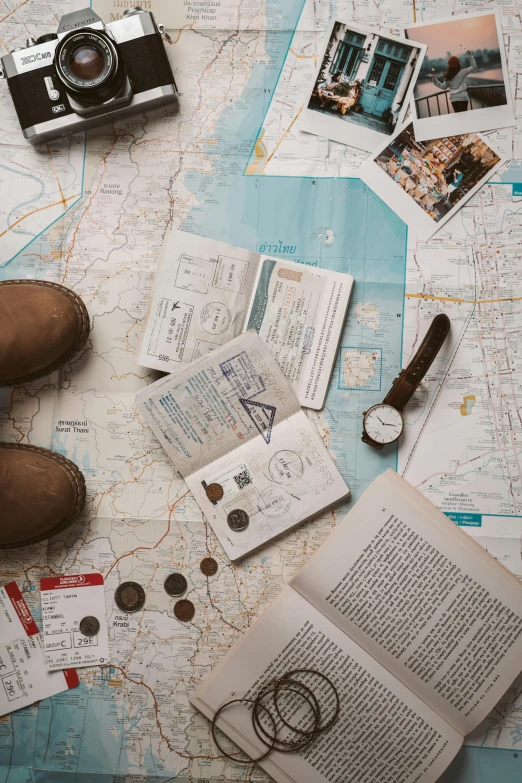 a pair of brown shoes sitting on top of a map, passport photo, flatlay book collection, explorer, maintenance