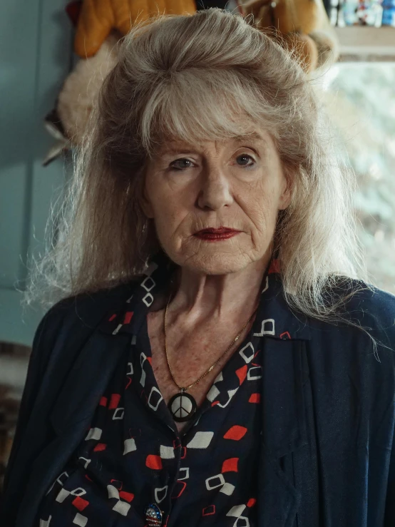 a woman standing in a kitchen next to a window, a portrait, by Penelope Beaton, close-up portrait film still, the look of an elderly person, portrait of kim petras, promo image