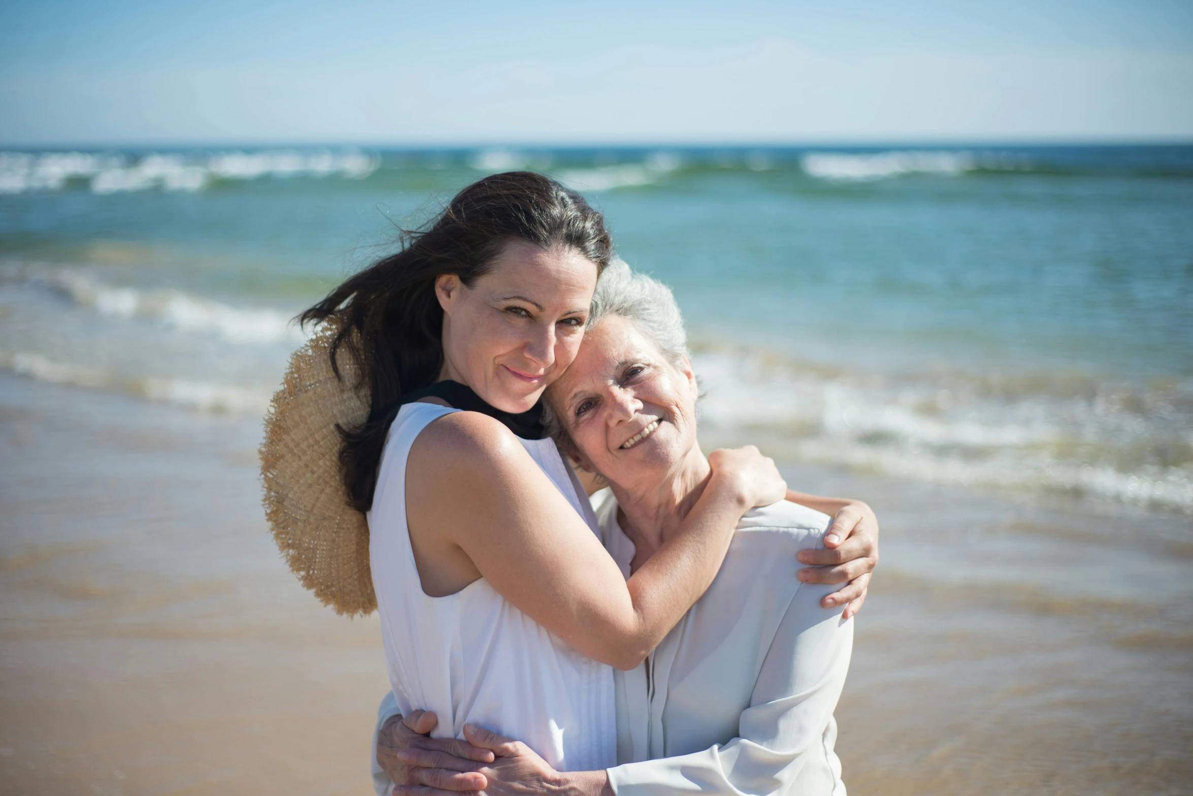 two women hugging each other on the beach, a portrait, by Arabella Rankin, pixabay contest winner, renaissance, maternal photography 4 k, avatar image, old and young, soft natural light