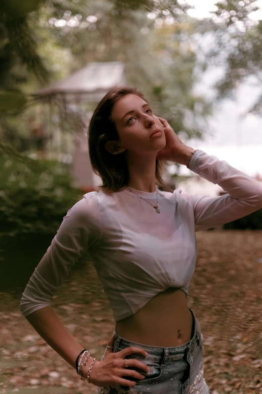 a woman standing in the woods holding a frisbee, an album cover, inspired by Elsa Bleda, realism, croptop, in white turtleneck shirt, young beautiful amouranth, thoughtful