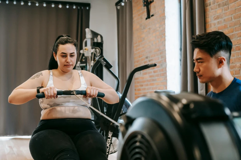 a man and a woman working out in a gym, by Emma Andijewska, pexels contest winner, hurufiyya, avatar image, body swelling about to explode, half asian, realistic image