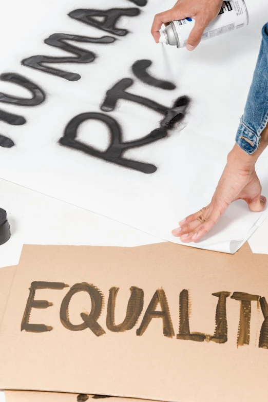 a person writing equality on a piece of paper, cut out of cardboard, thumbnail, full body image, banners
