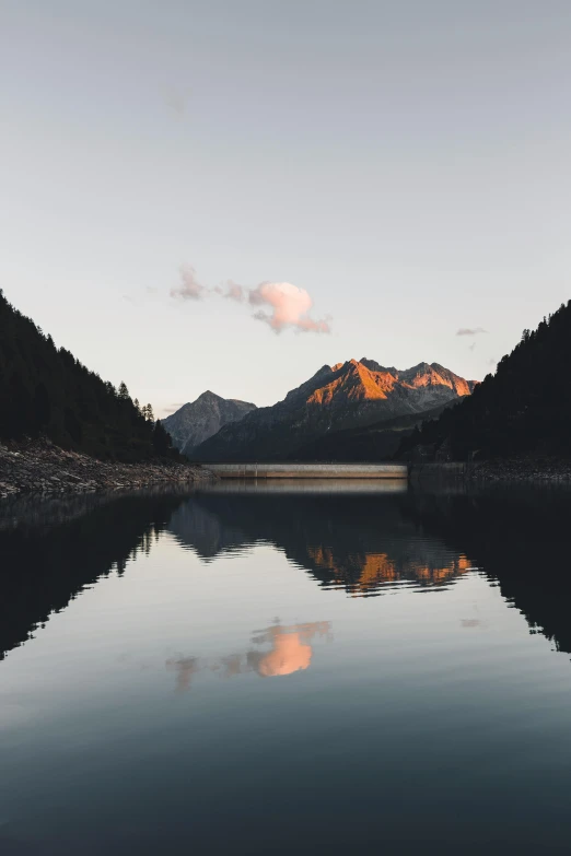 a body of water with mountains in the background, pexels contest winner, minimalism, late summer evening, symmetrical shot, multiple stories, 1 4 9 3