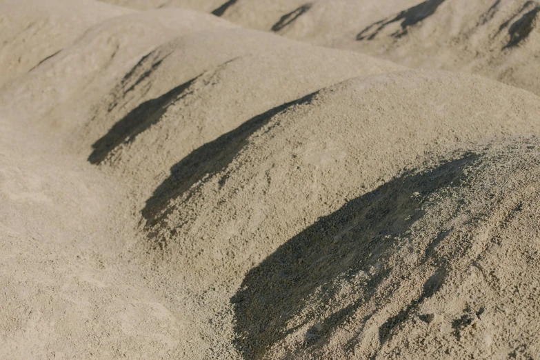 a pile of sand sitting on top of a sandy beach, unsplash, figuration libre, background image, pbr material, hillside, taupe