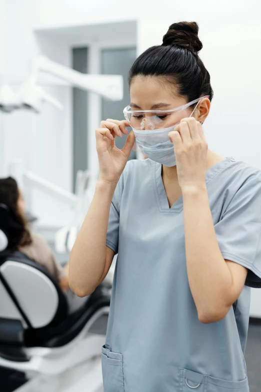 a woman wearing a face mask in a dentist's office, happening, grey, multiple stories, null, asian women