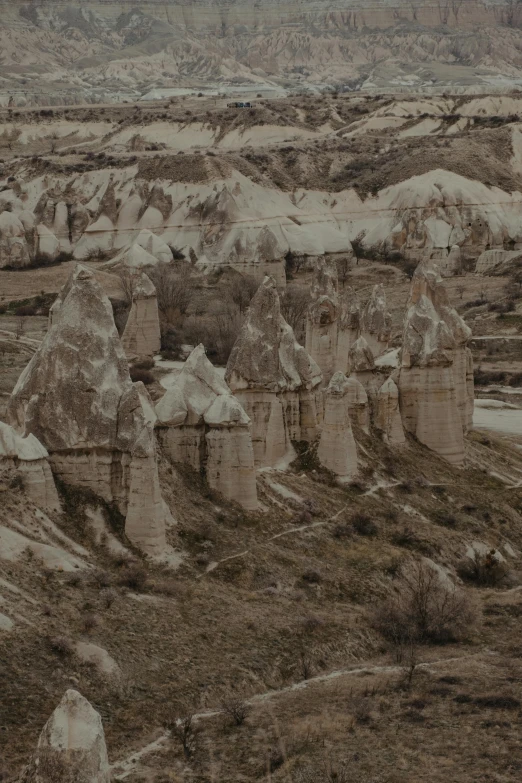 a black and white photo of a rocky landscape, by irakli nadar, photochrom print, turkey, majestic spires, brown