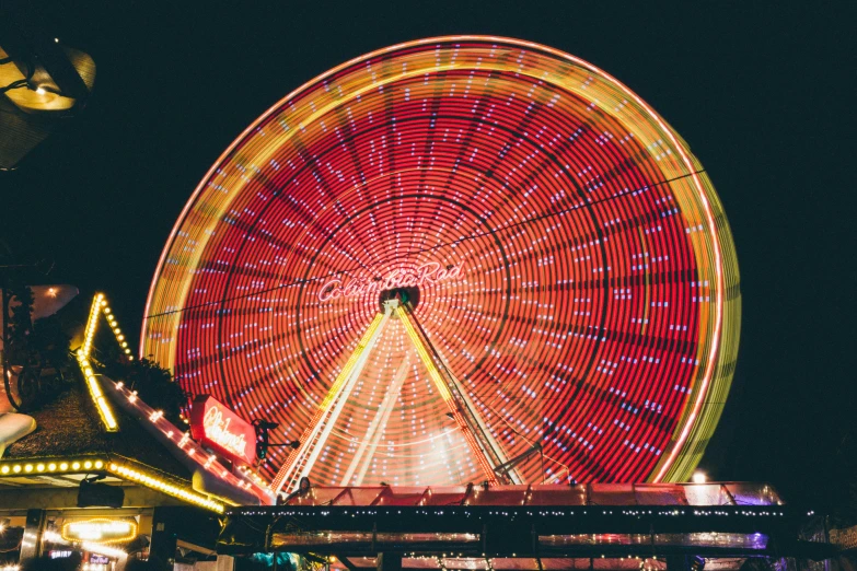 a ferris wheel is lit up at night, pexels contest winner, red rim light, instagram post, at california adventure, high resolution