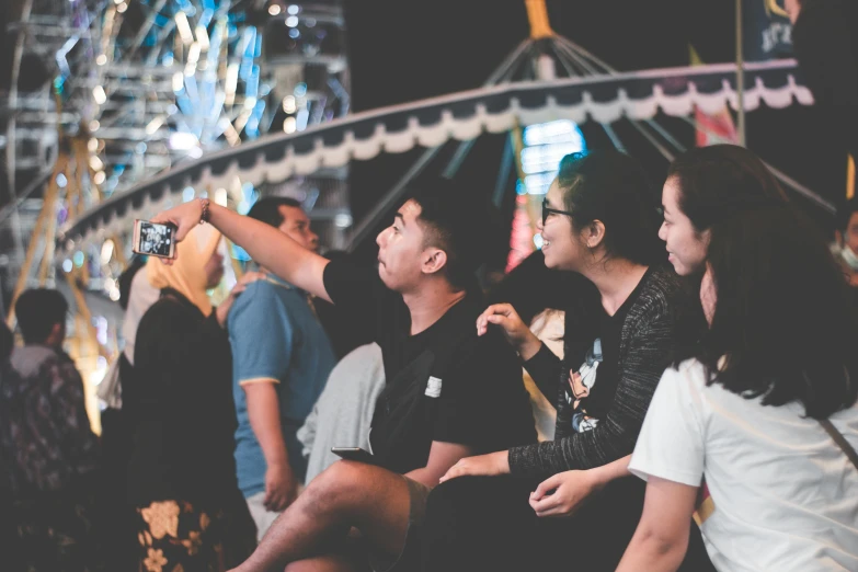 a group of people sitting next to each other at a carnival, pexels contest winner, happening, avatar image, smartphone photo, profile image, singapore ( 2 0 1 8 )