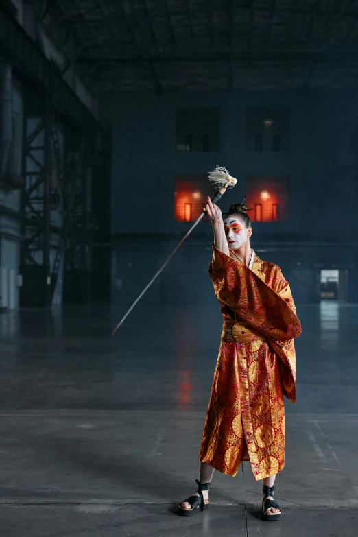 a man in a red robe holding a sword, inspired by Kanō Hōgai, unsplash, visual art, circus performance, cai guo-qiang, woman in a dark factory, palace dance