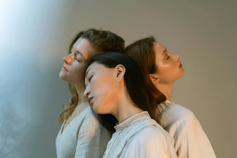 a group of women standing next to each other, an album cover, inspired by Anna Füssli, trending on unsplash, aestheticism, woman with porcelain skin, gentle calm doting pose, three heads, asian women