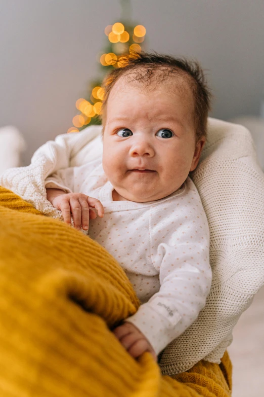 a close up of a baby wrapped in a blanket, incoherents, in a comfortable chair, surprised frown, uwu, commercially ready