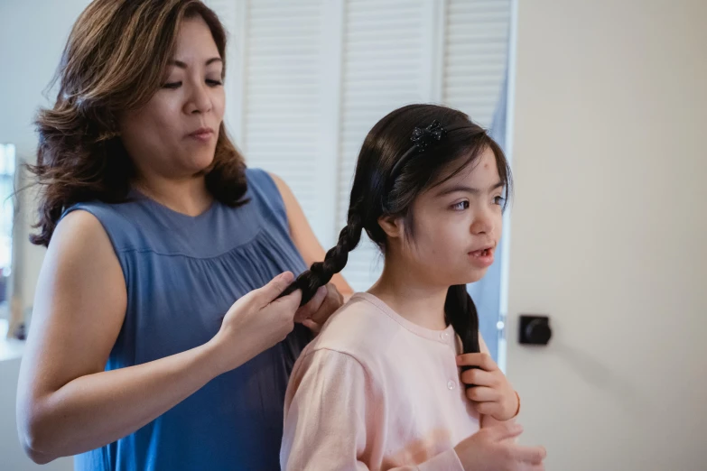 a woman is combing a young girl's hair, inspired by Ruth Jên, pexels contest winner, hurufiyya, avatar image, marfan syndrome, hunched shoulders, manuka