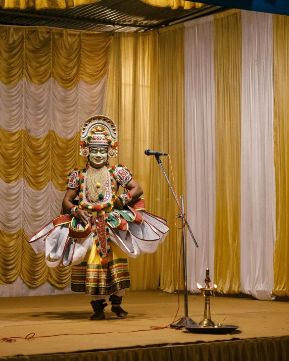 a man that is standing on a stage, inspired by Odhise Paskali, happening, kerala motifs, lgbtq, square, mask