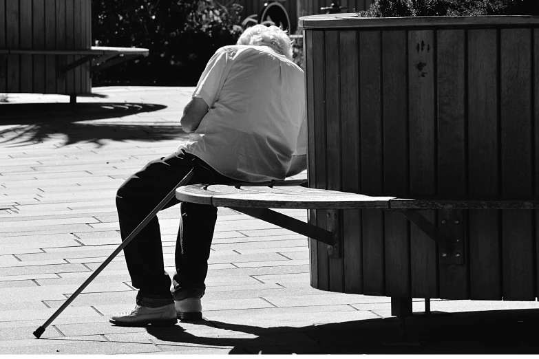 a black and white photo of a person sitting on a bench, with a walking cane, 15081959 21121991 01012000 4k, an elderly, having fun in the sun