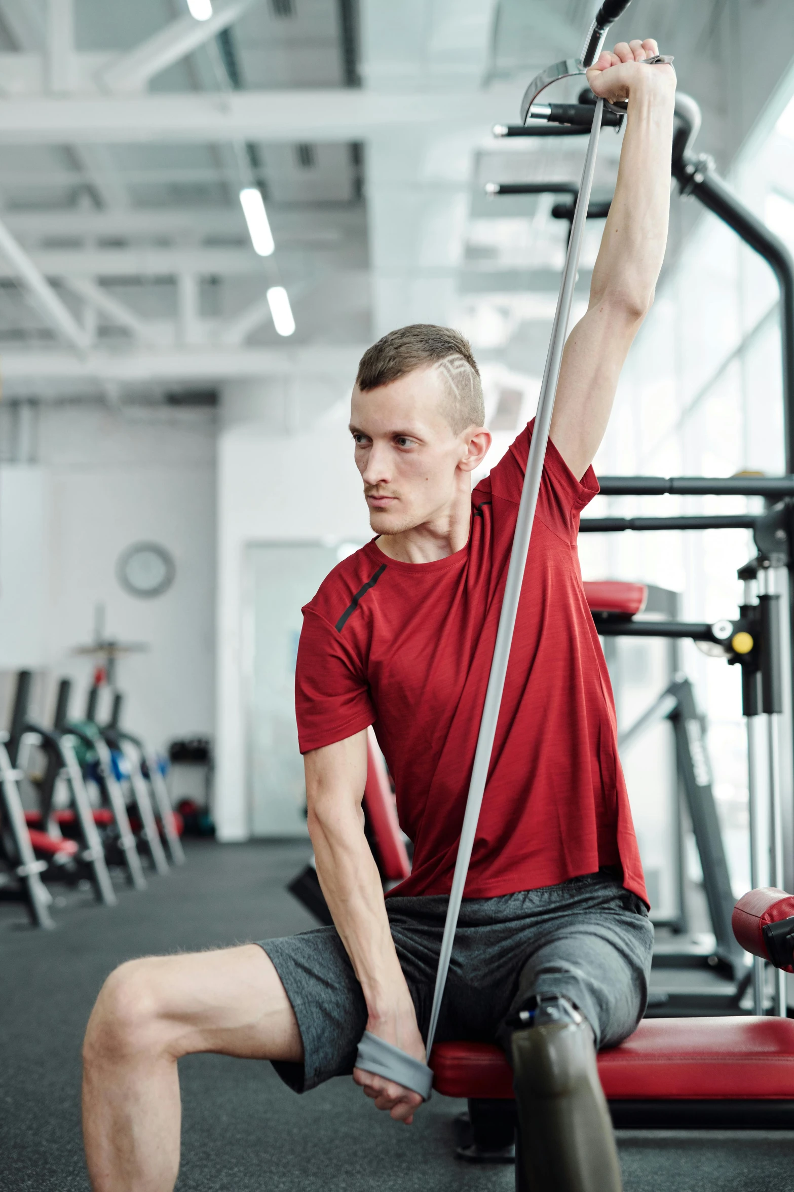 a man sitting on top of a machine in a gym, pexels contest winner, renaissance, young male with walking stick, long neck, gif, multi-part