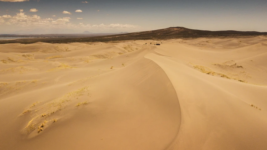 a large sand dune in the middle of a desert, a picture, by Adam Marczyński, land art, fan favorite, tengri, overview, big island