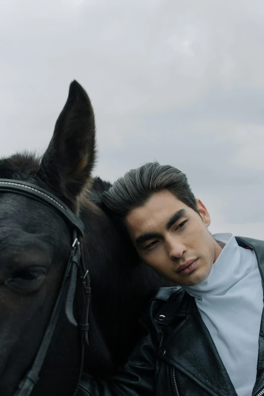 a man in a leather jacket standing next to a horse, inspired by Zhang Han, trending on pexels, androgynous face, gray skin, slide show, asian human