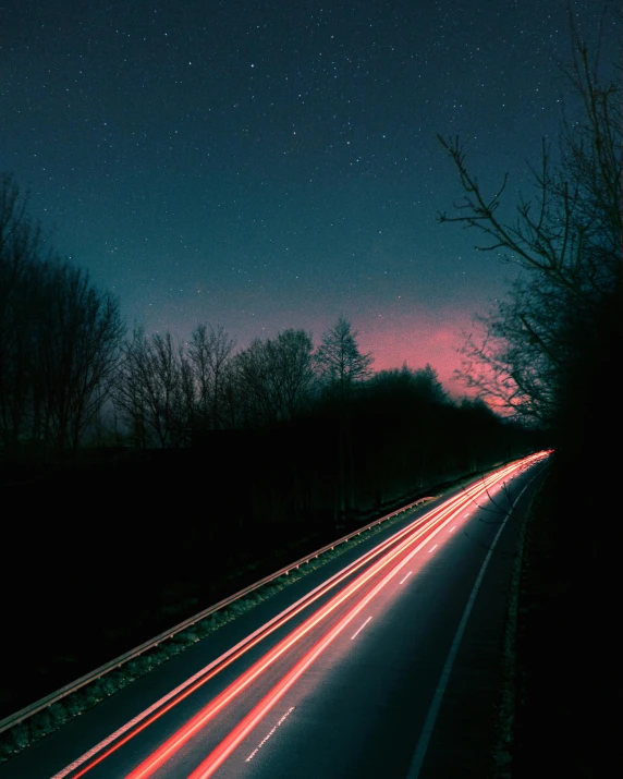 a long exposure photo of a highway at night, an album cover, unsplash contest winner, pink light, blue and red glowing lights, profile picture, ansel ]