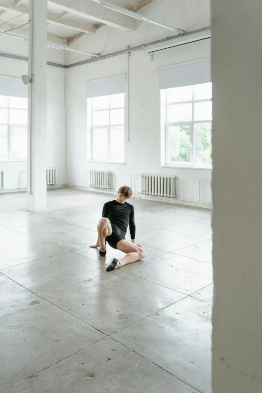 a man sitting on the floor in an empty room, by Nina Hamnett, dasha taran, indoor picture