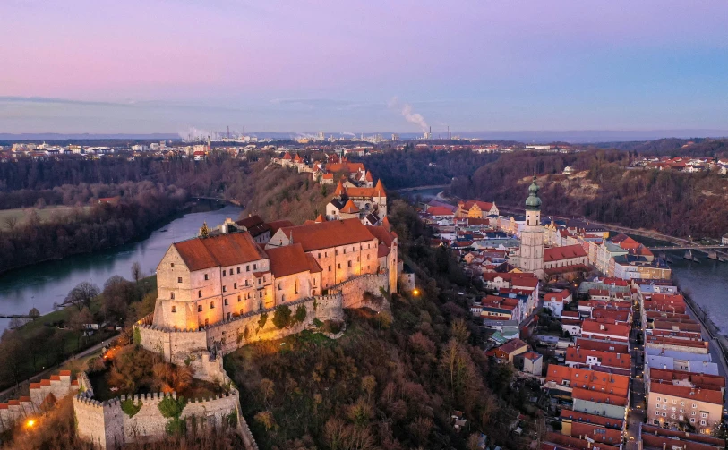 a castle sitting on top of a hill next to a river, by Daniel Lieske, pexels contest winner, renaissance, drone view of a city, 8k hdr dusk light, white buildings with red roofs, screensaver