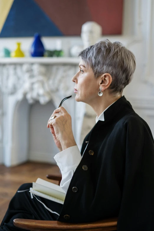 a woman sitting in a chair with a pipe in her mouth, inspired by Marie-Gabrielle Capet, pexels contest winner, short grey hair, inspect in inventory image, elegant study, profile image