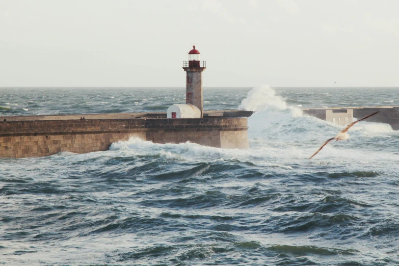 a large body of water with a lighthouse in the background, an album cover, by Elsa Bleda, pexels contest winner, figuration libre, extremely strong wind, lisbon, low pressure system, youtube thumbnail