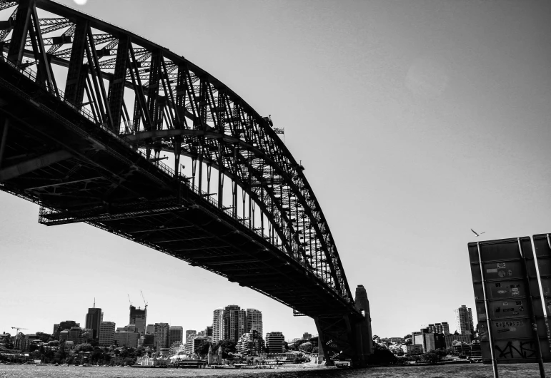 a black and white photo of the sydney harbour bridge, inspired by Sydney Carline, pexels contest winner, 1024x1024, photographic print, skyline, rusty