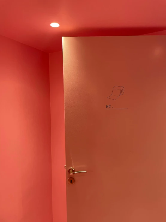 a white toilet sitting in a bathroom next to a pink wall, an album cover, by Alexis Grimou, door, red, showstudio, hotel room