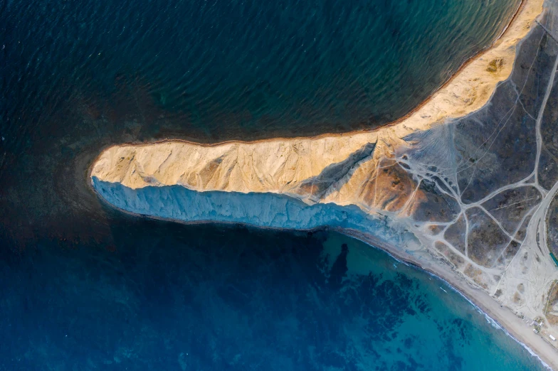 an aerial view of a large body of water, by Lee Loughridge, pexels contest winner, land art, cyprus, chalk cliffs above, inuit heritage, slide show