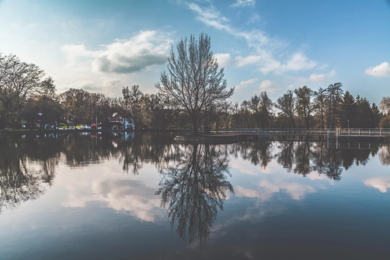 a body of water with trees in the background, a picture, pexels contest winner, visual art, mirror world, bucklebury ferry, symmetrical 4k, large sky