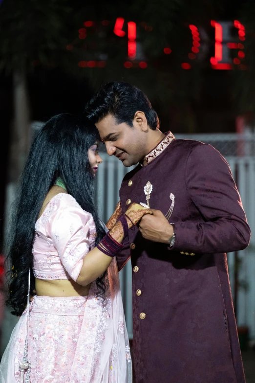 a man and a woman standing next to each other, an album cover, by Rajesh Soni, pexels, hurufiyya, couple dancing, concert photo, profile pic, ornately dressed