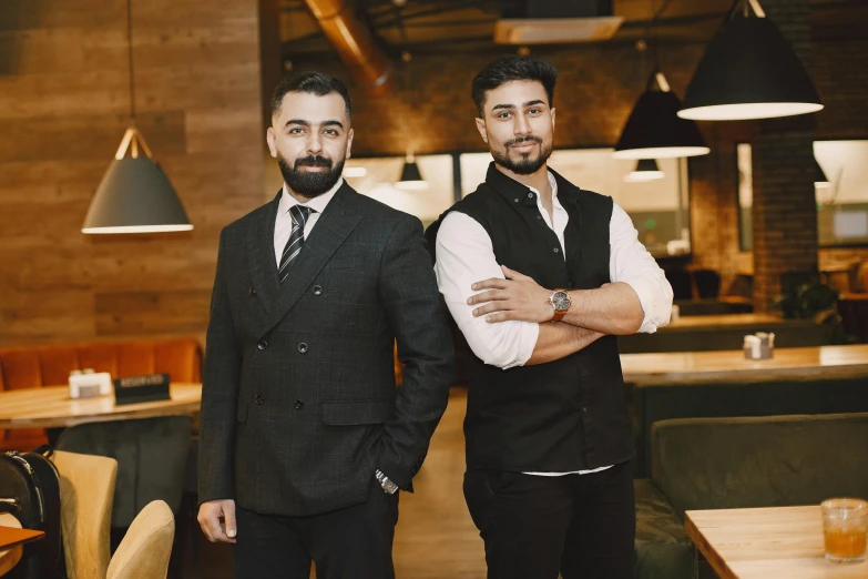 two men standing next to each other in a restaurant, a portrait, pexels contest winner, hurufiyya, avatar image, high quality image, ayanamikodon and irakli nadar, corporate photo