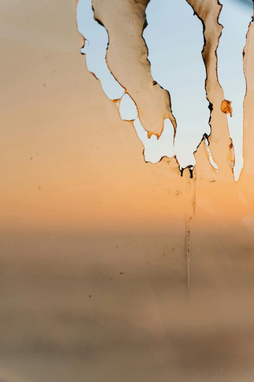 a close up of a fire hydrant with a sky in the background, a picture, inspired by Lucio Fontana, shattered abstractions, sunrise light, view out of a window, honey dripping from ceiling