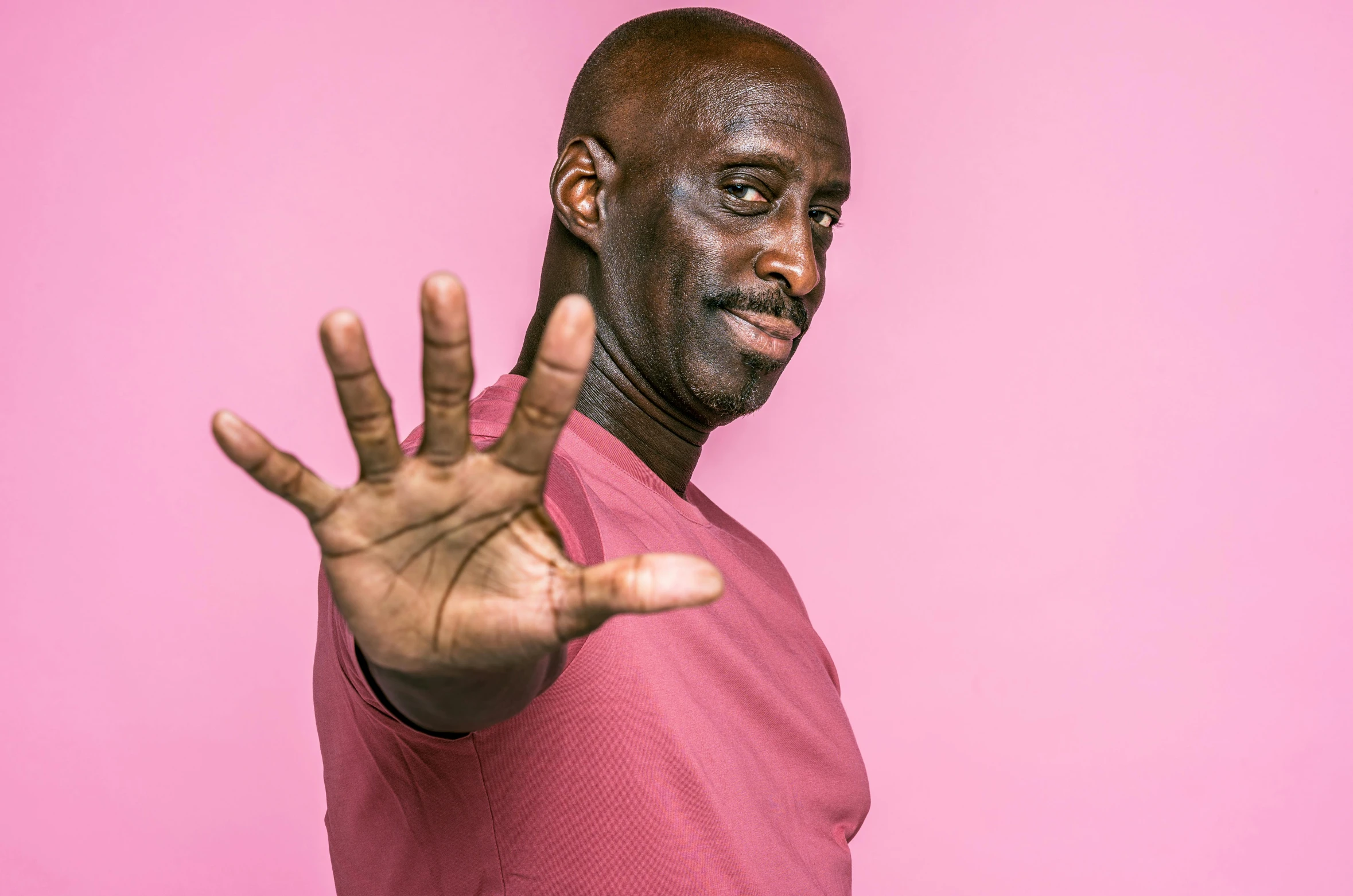 a man making a stop sign with his hands, an album cover, by Winona Nelson, pexels contest winner, les nabis, lance reddick, pink power, headshot profile picture, 15081959 21121991 01012000 4k