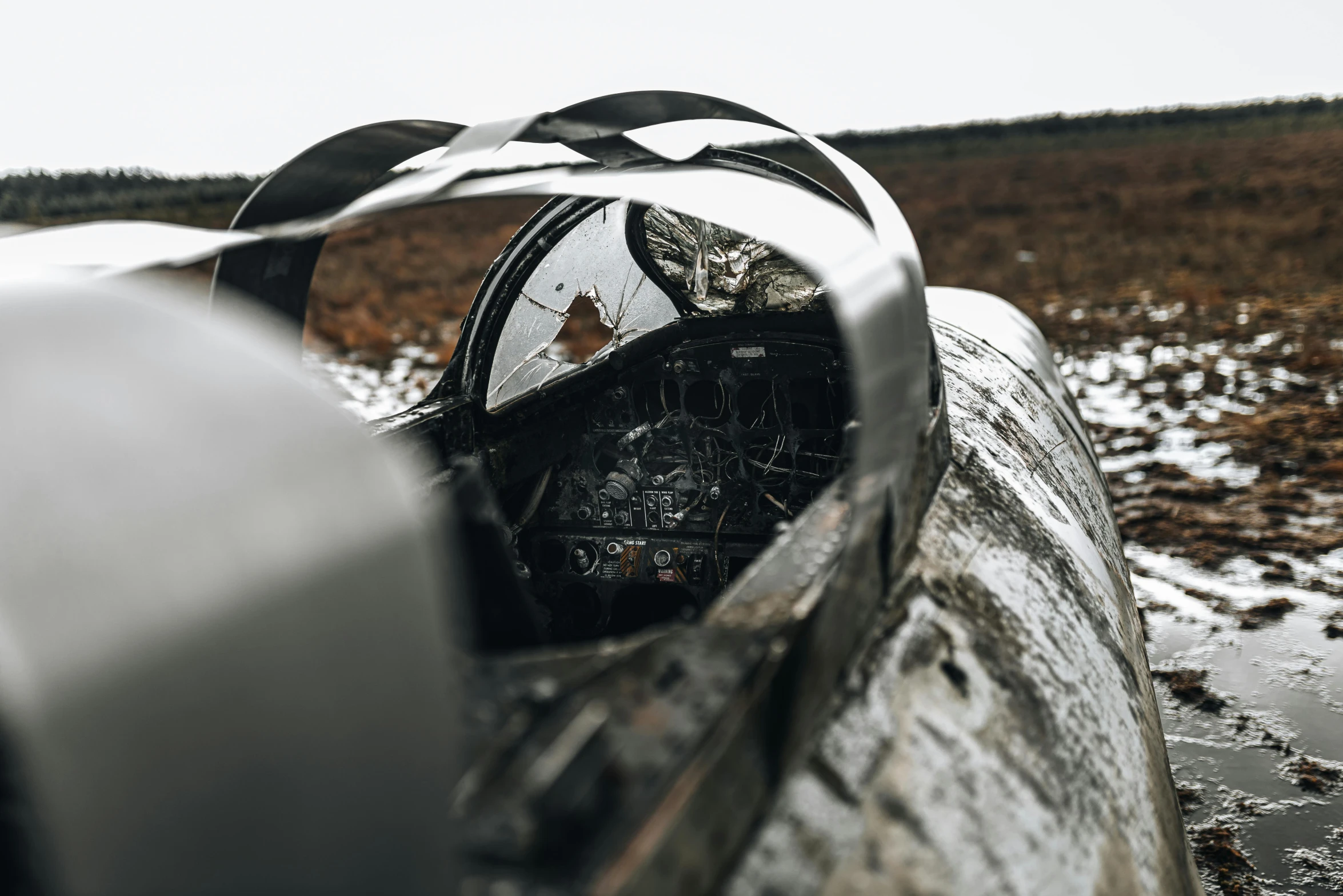 a plane sitting on top of a muddy field, unsplash, auto-destructive art, glass and metal : : peugot onyx, inside mirror, crashed in roswell, detailed medium format photo