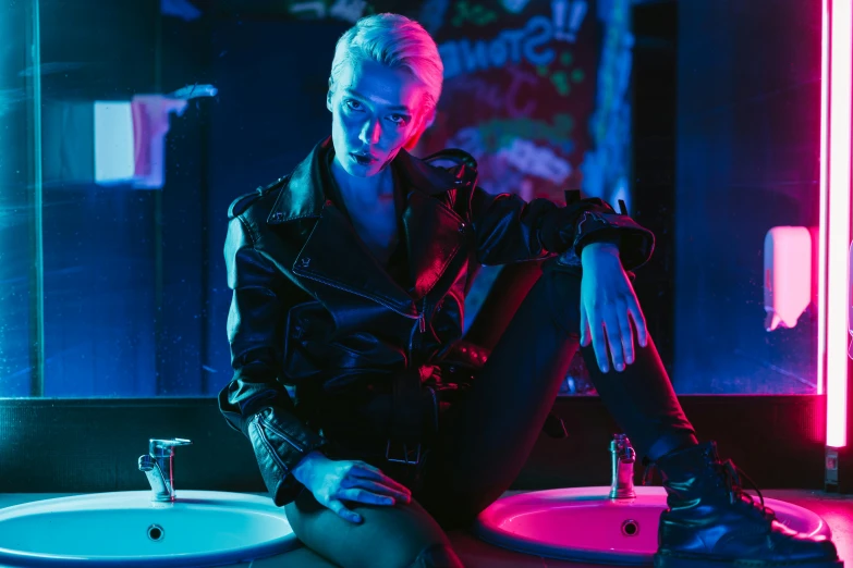 a woman sitting on top of a bathroom sink, cyberpunk art, inspired by Elsa Bleda, trending on pexels, wearing cyberpunk leather jacket, annie leonhart in a neon city, blue mood, betty cooper