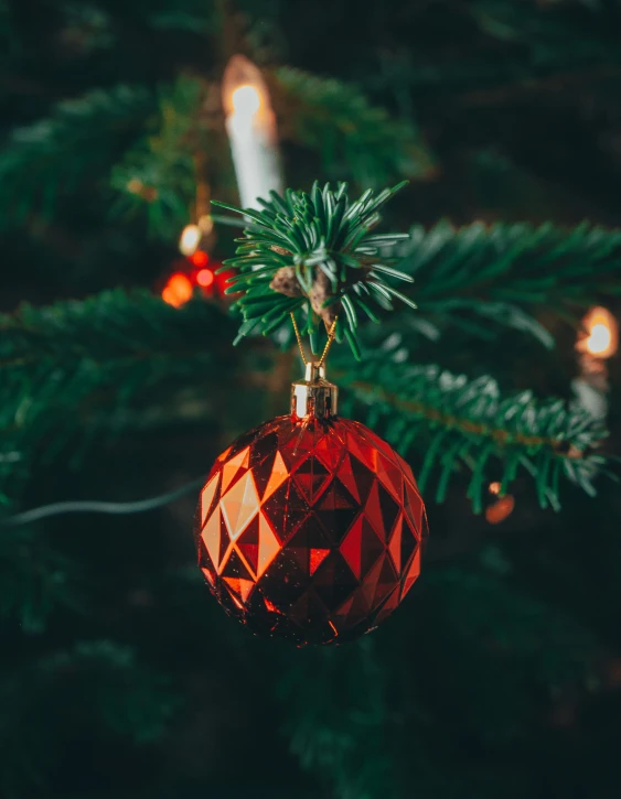 a red ornament hanging from a christmas tree, inspired by Ernest William Christmas, pexels, dark grey and orange colours, thumbnail, low detail, large tree