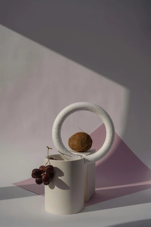 a white cup sitting on top of a table, an abstract sculpture, inspired by Isamu Noguchi, fruits, ring light, - 9, product