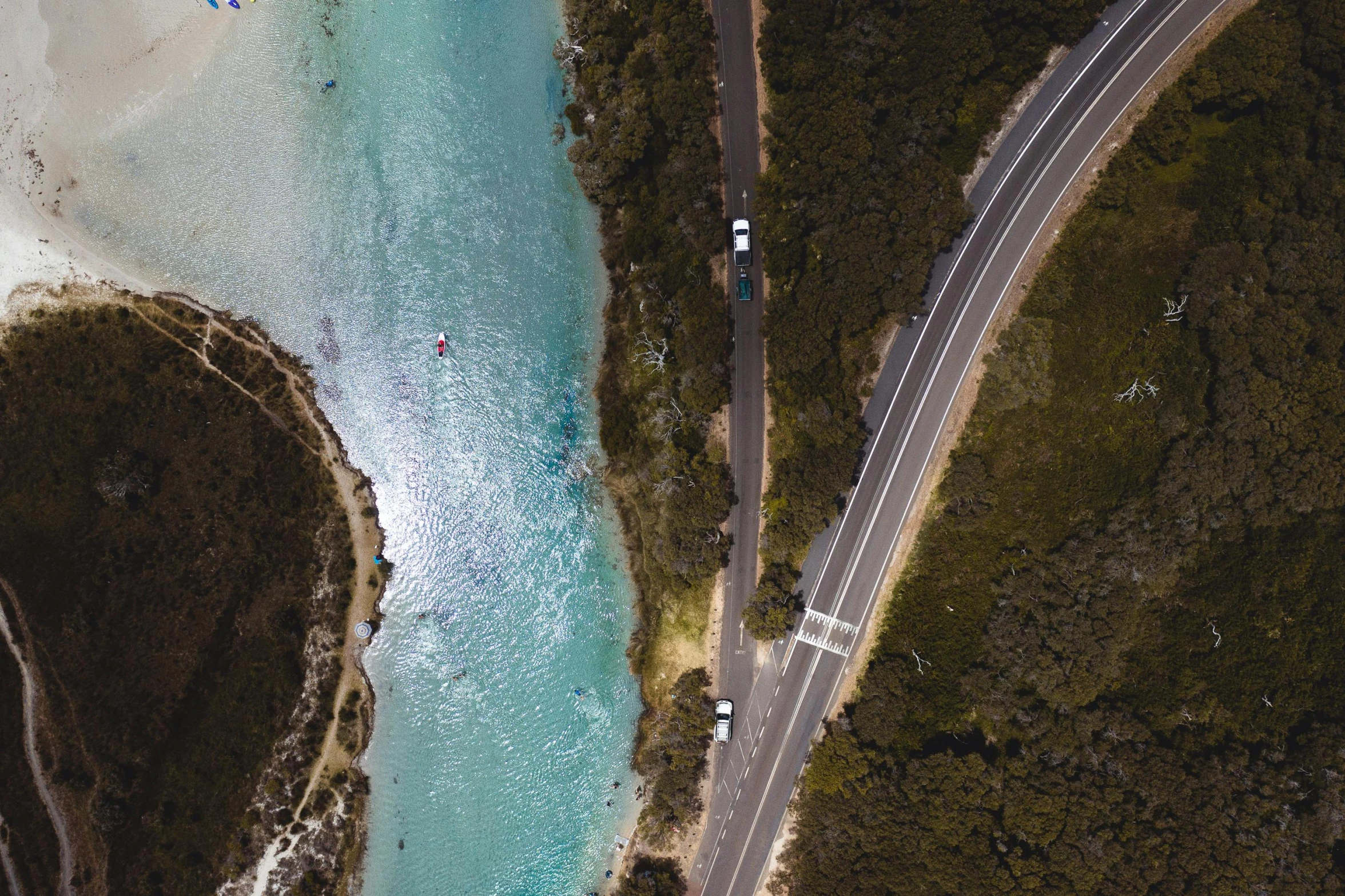 an aerial view of a road next to a body of water, by Lee Loughridge, pexels contest winner, hurufiyya, sydney hanson, thumbnail, zachary corzine, celebrating