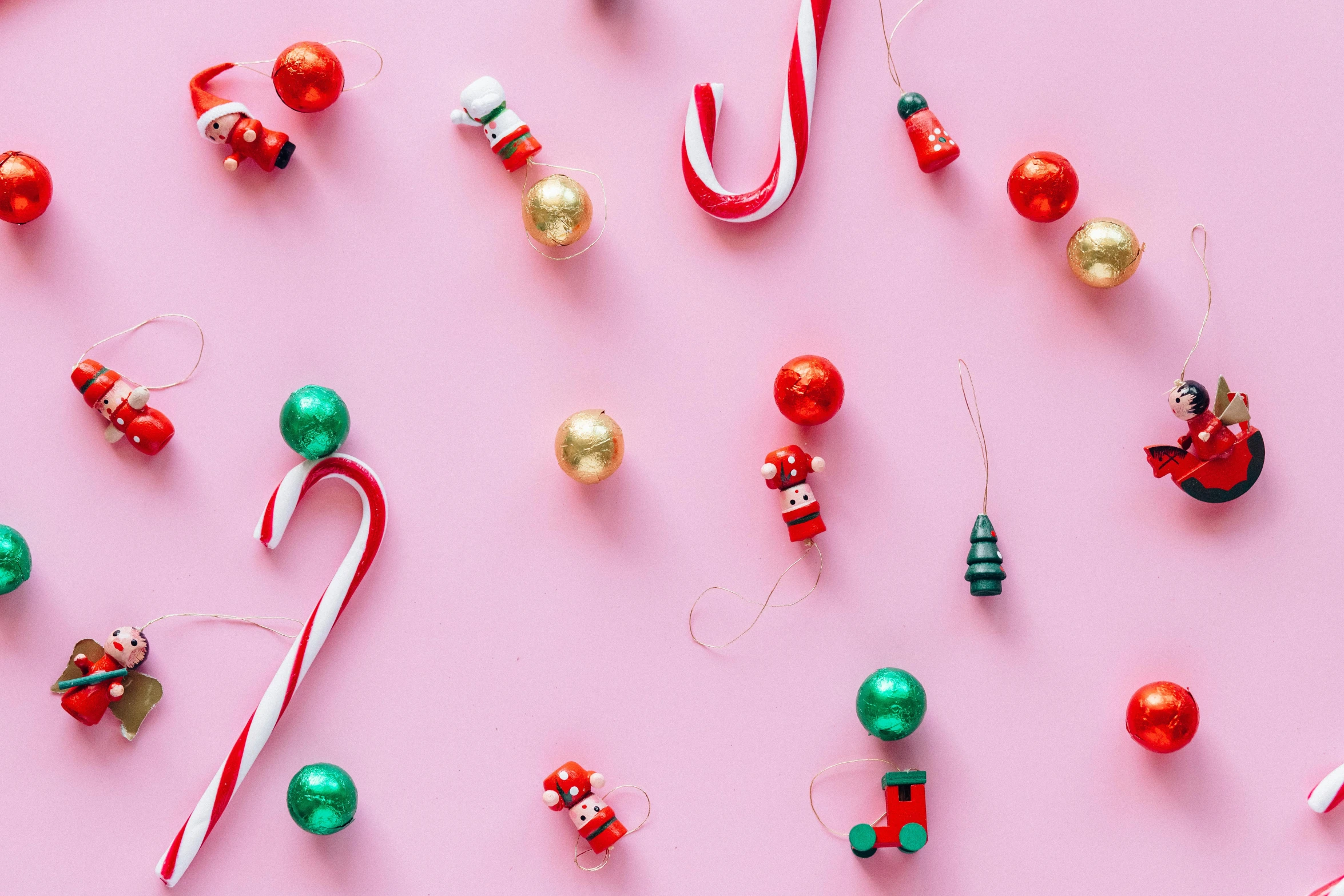 a collection of christmas ornaments on a pink surface, trending on pexels, candy canes, background image, thumbnail, i és complex