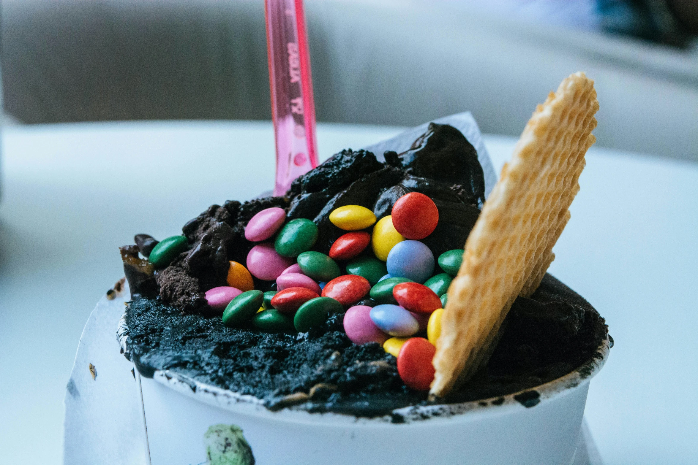 an ice cream sundae sitting on top of a table, by Adam Marczyński, pexels contest winner, colorful ferrofluid armor, cookie monster, gardening, licorice allsort filling