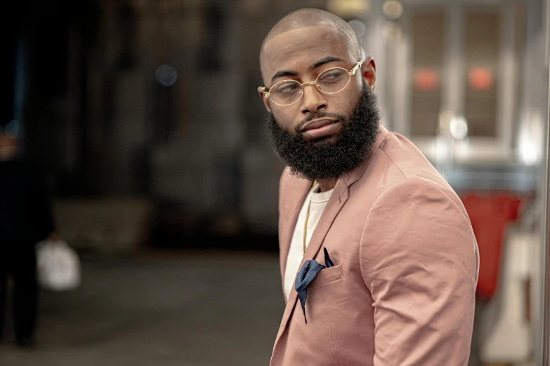 a man with a beard wearing a pink suit, inspired by Charles Alston, trending on pexels, brown buzzcut, riyahd cassiem, thicc, center frame portrait