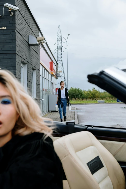 a woman sitting in the driver's seat of a car, an album cover, by Tobias Stimmer, maxim sukharev, convertible, i-d magazine, aurora aksnes and zendaya
