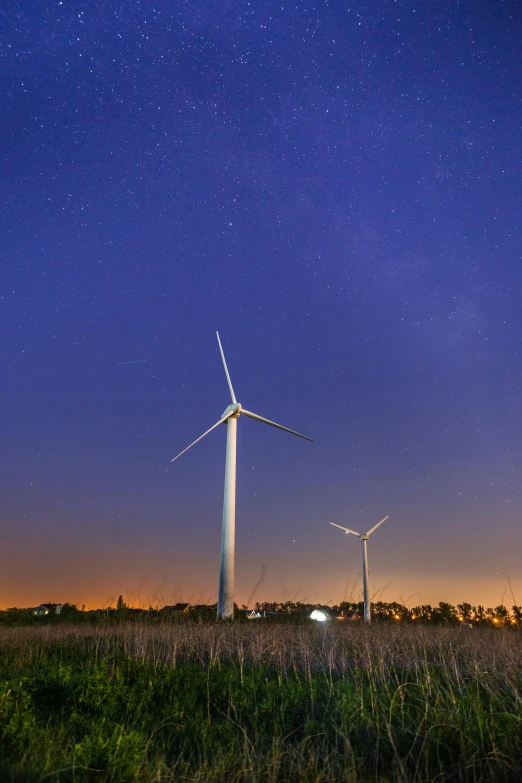 three wind turbines in a field at night, by Jan Tengnagel, pexels contest winner, epic scale ultrawide angle, blue sky, southern cross, late summer evening